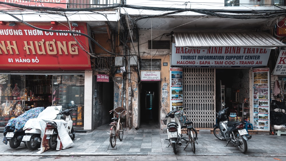 bicycles parked beside brown building during daytime