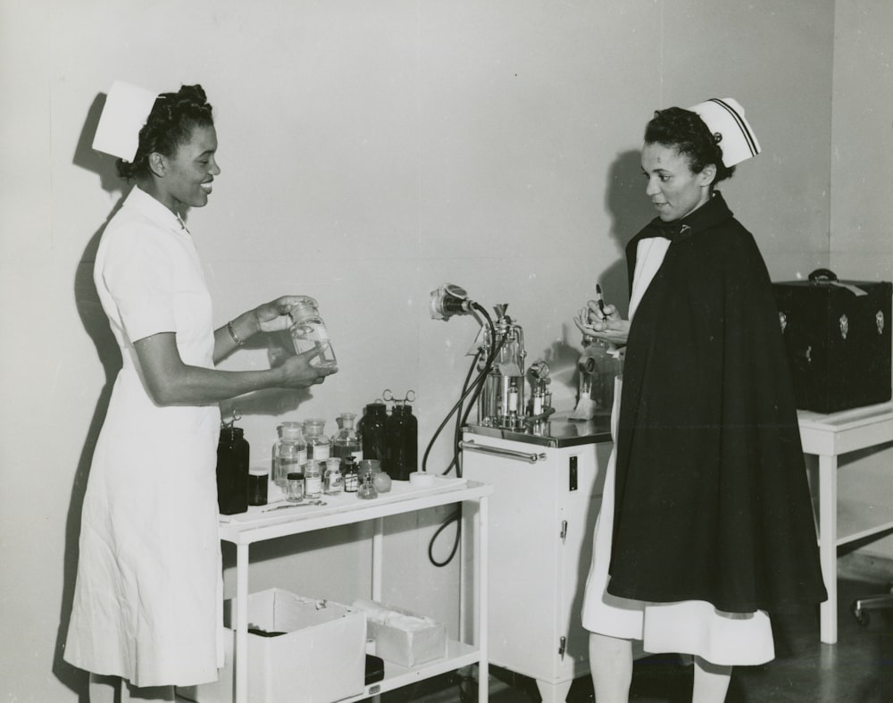 two female nurses talking in a hospital room