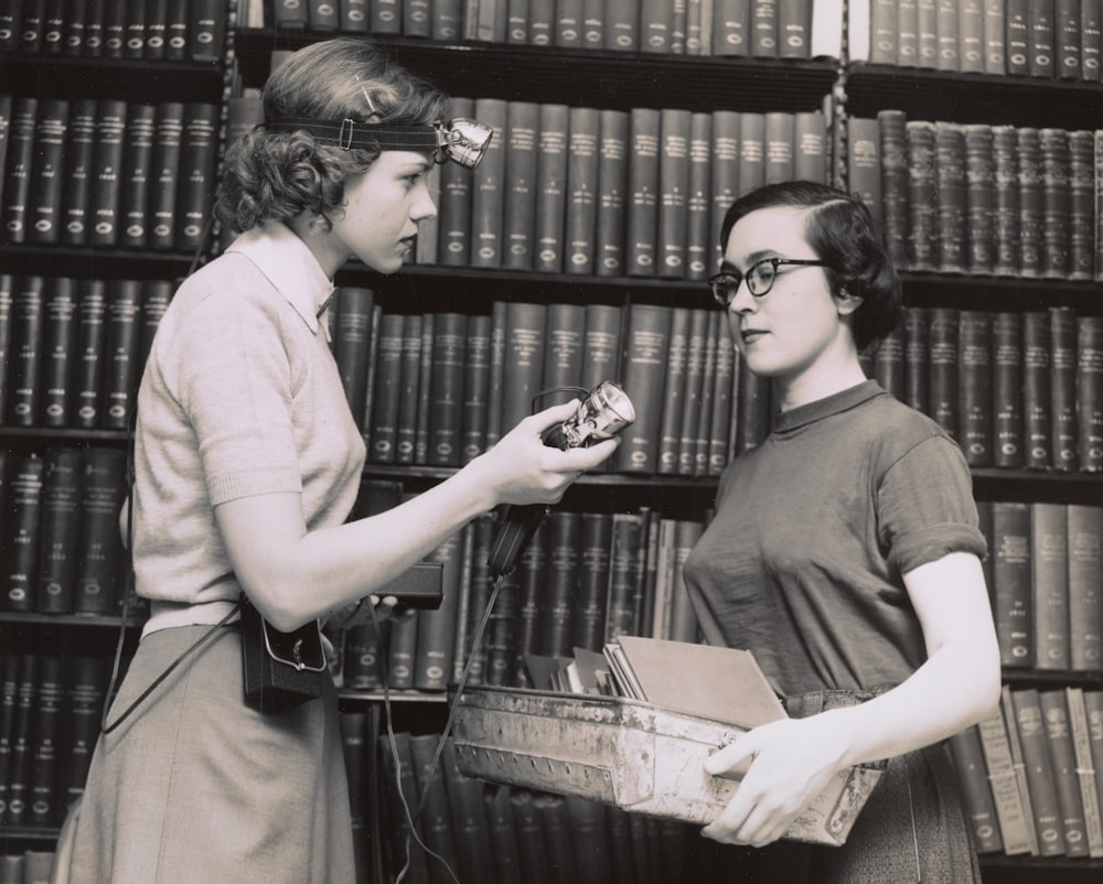 two women talking in the library 