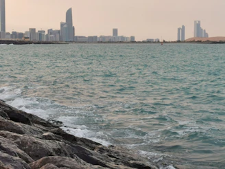 Fun line illustration of a city skyline blending into waves, representing tourism and travel.