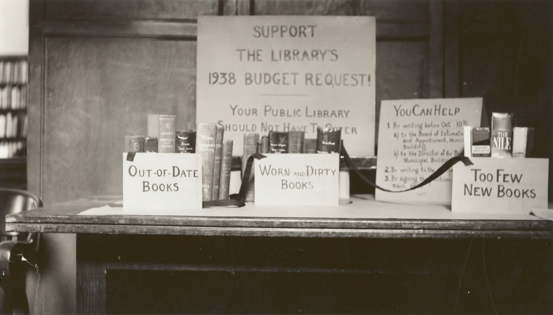 white printer paper on brown wooden table in support of the library