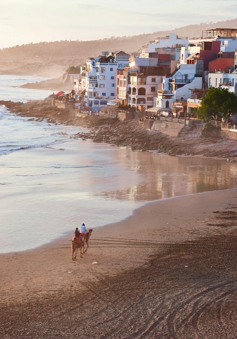 person in black shirt walking on seashore during daytime