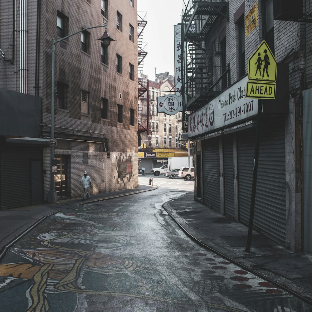 empty street in between buildings during daytime