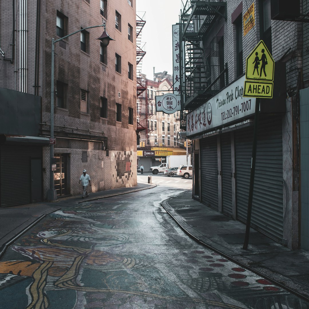empty street in between buildings during daytime