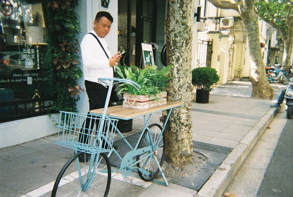 man in white dress shirt and black pants holding white and brown wooden cart