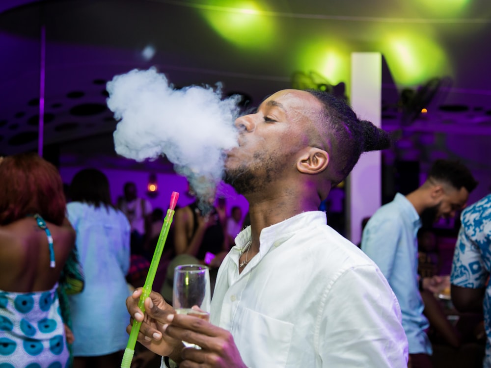 man in white dress shirt smoking