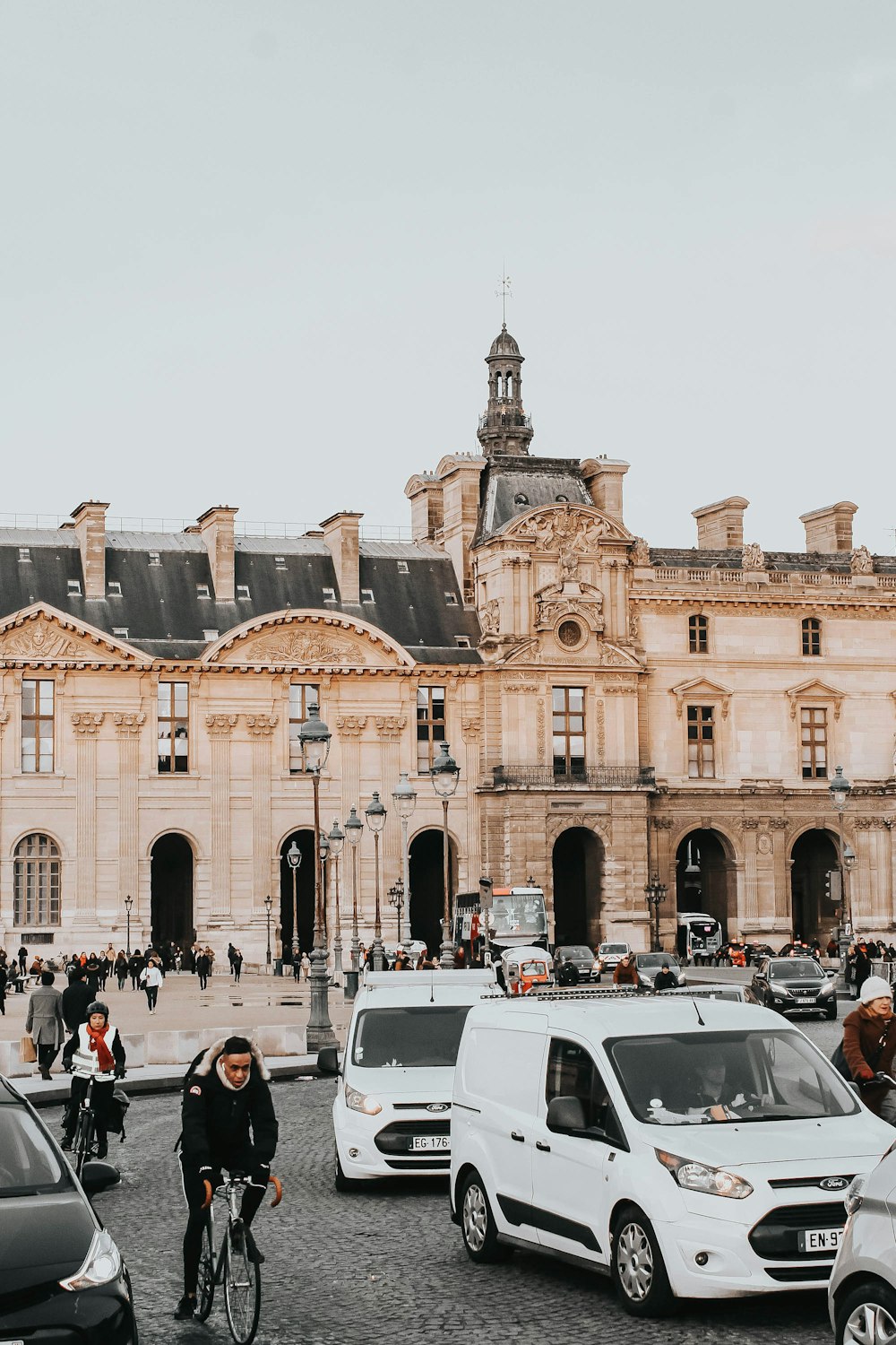 cars parked in front of brown concrete building during daytime