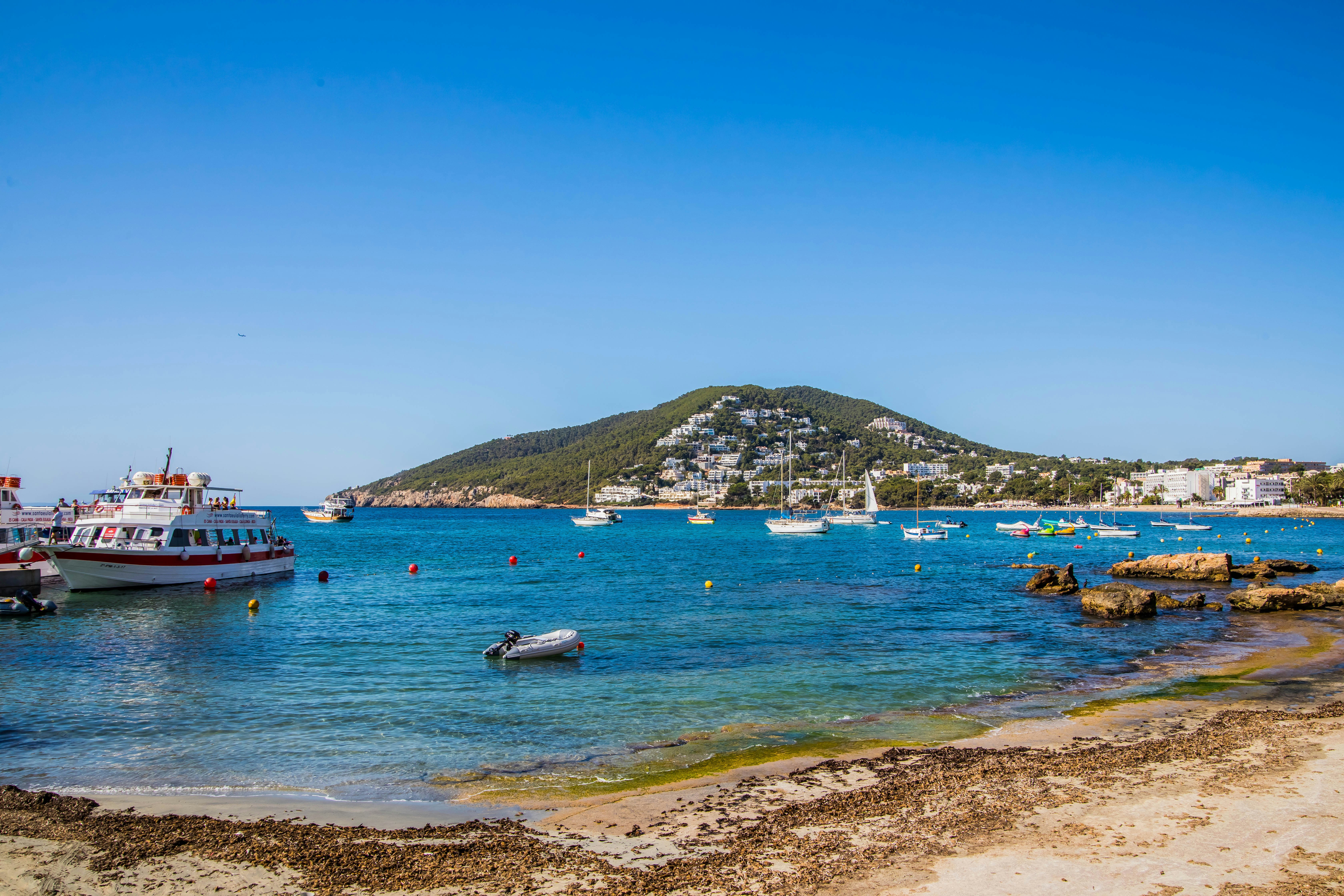 people riding on white boat on sea during daytime, Siesta Hill, Santa Eulalia
