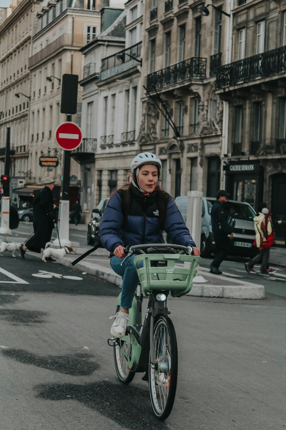 man in black jacket riding on green bicycle during daytime