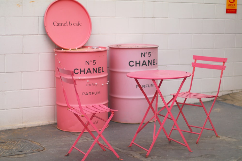 흰 벽 옆에 분홍색 금속 의자