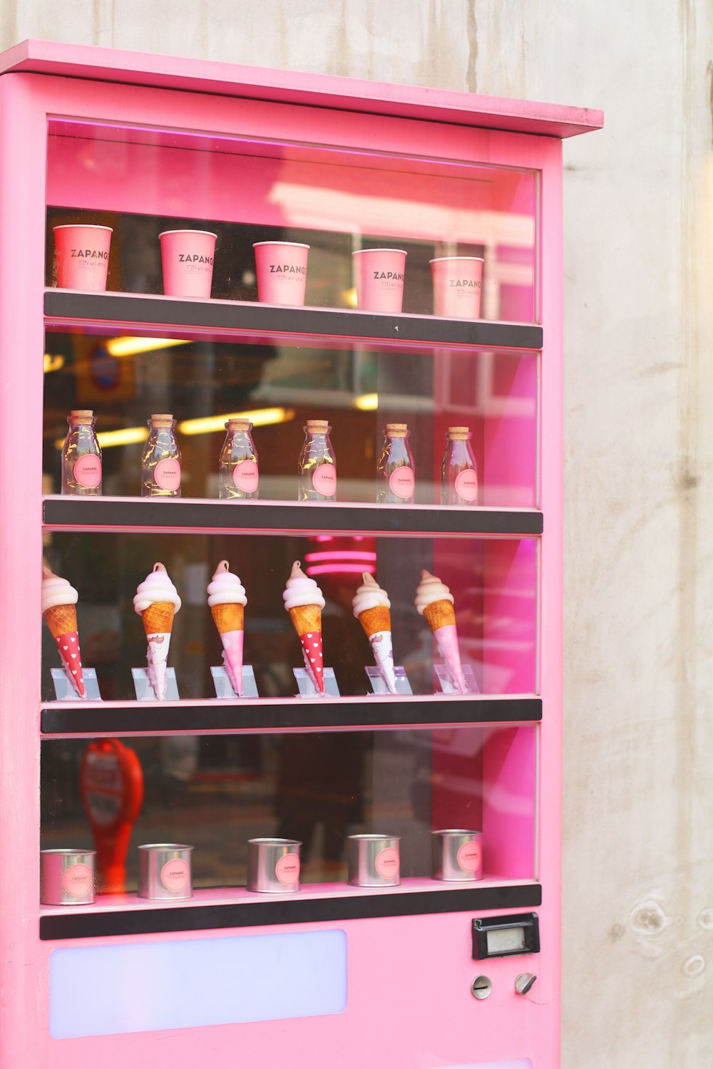 bottles on pink wooden shelf