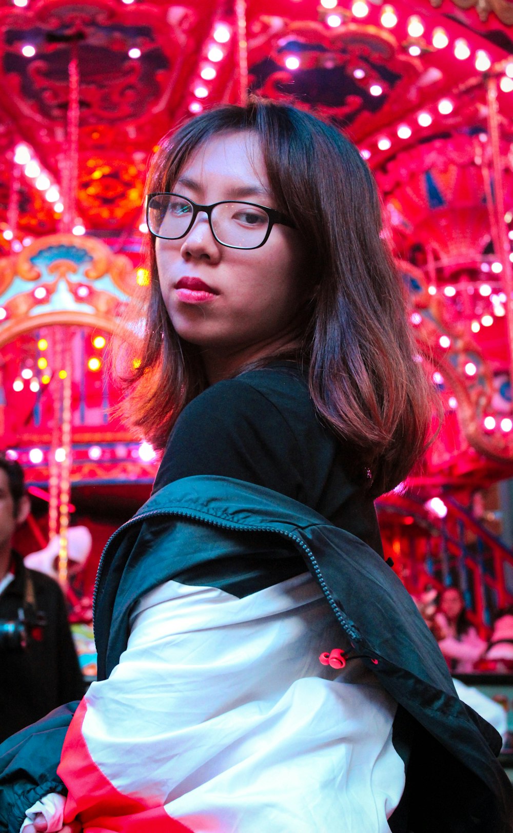 woman in black and white jacket wearing black framed eyeglasses