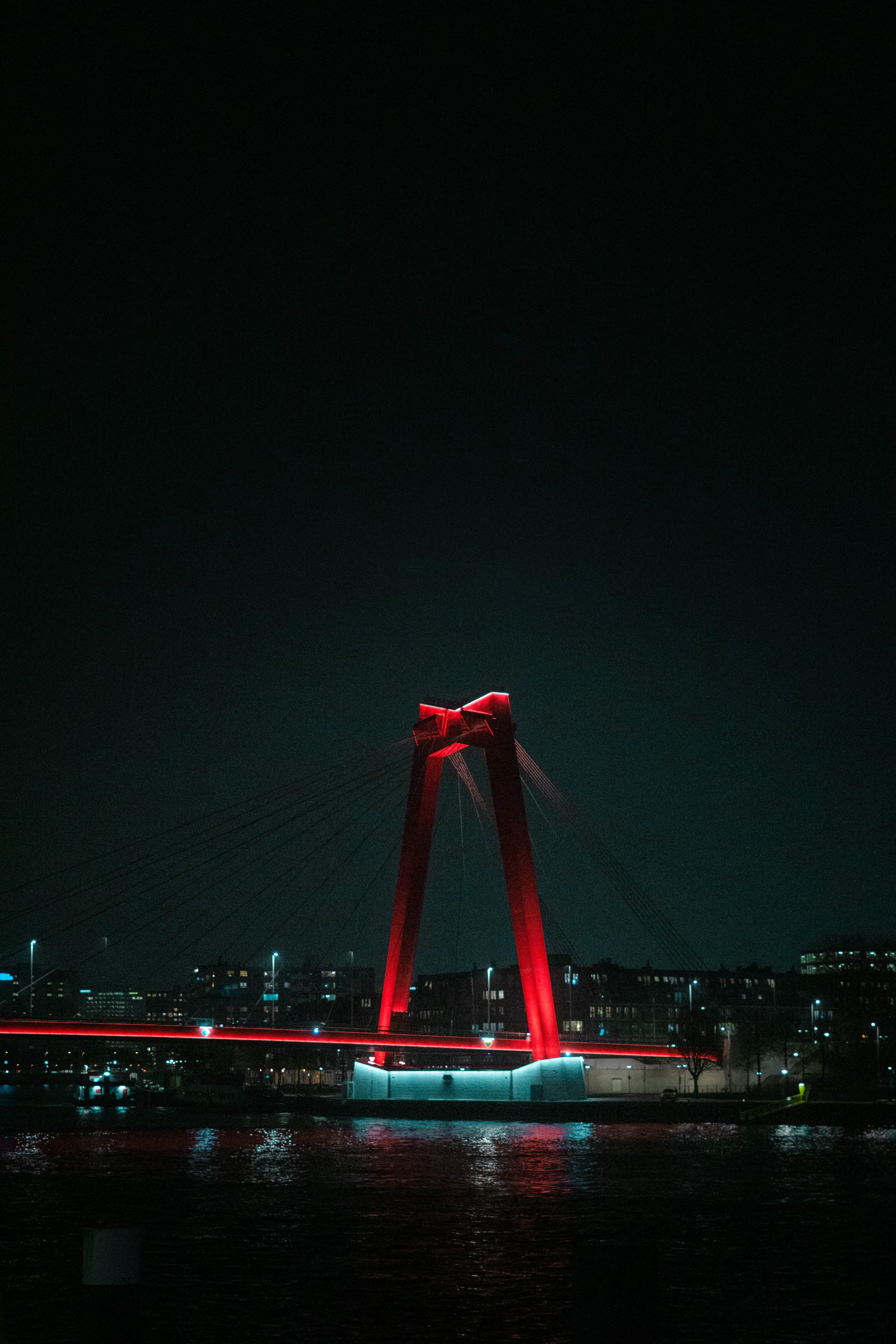 red bridge with blue lights during night time