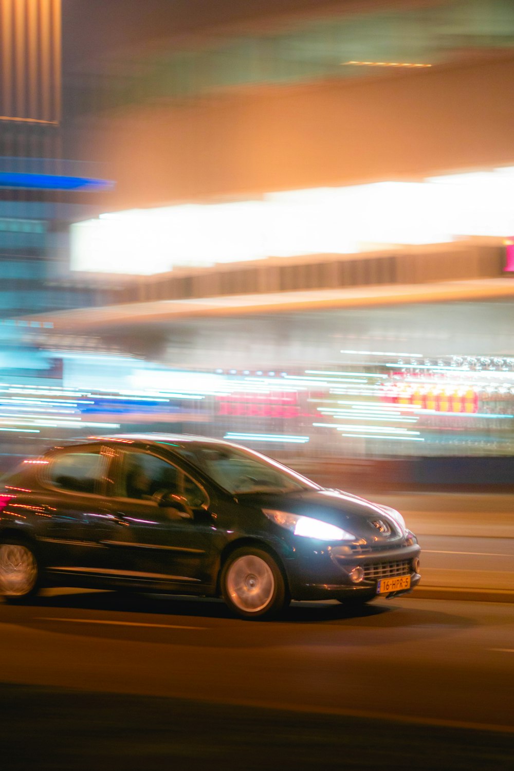 black sedan on road during night time