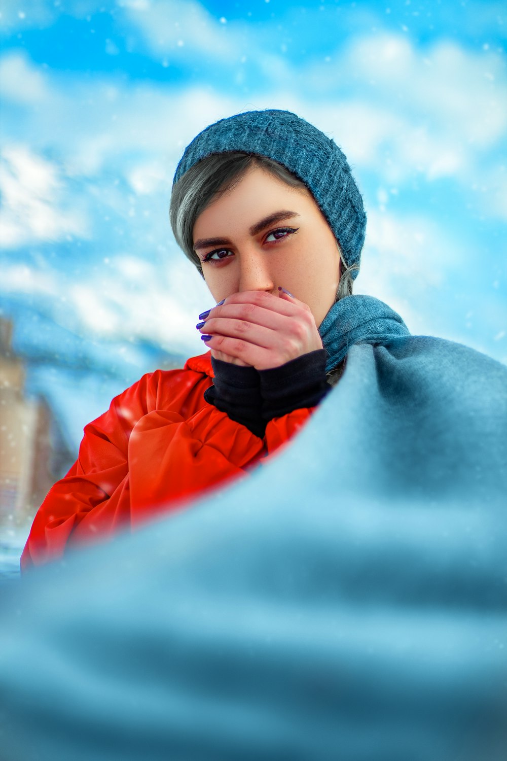 woman in blue knit cap and orange jacket