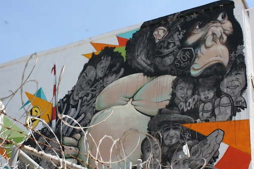 A gritty street mural showing a punk monkey with a thoughtful expression, symbolizing individualism.