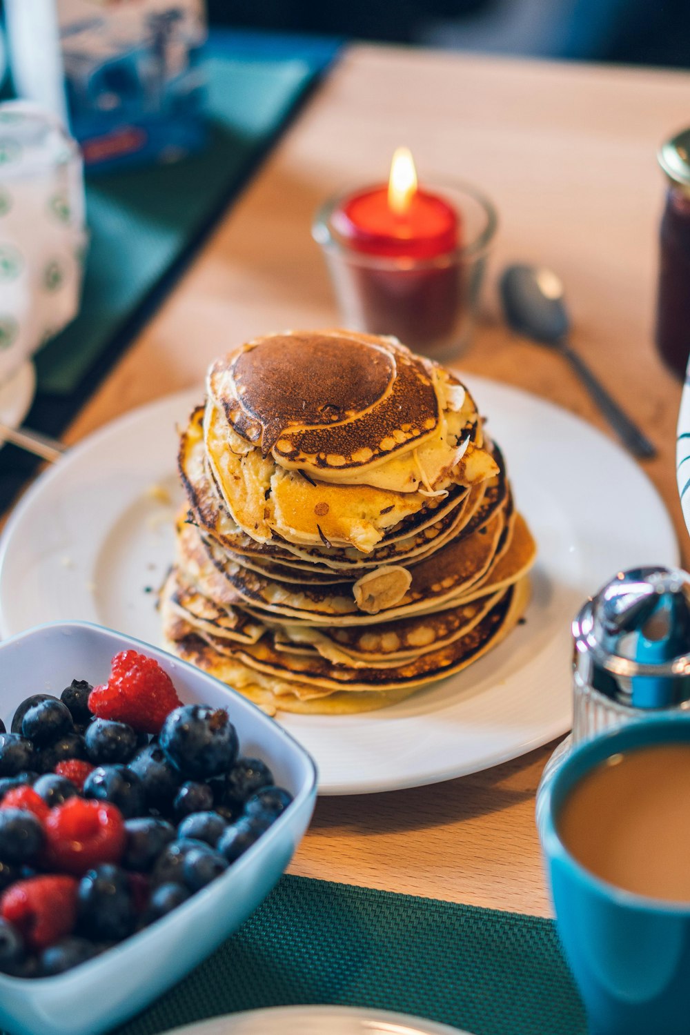 pancakes with berries on white ceramic plate