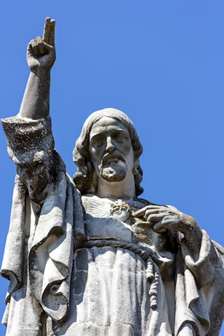 gray concrete statue under blue sky during daytime