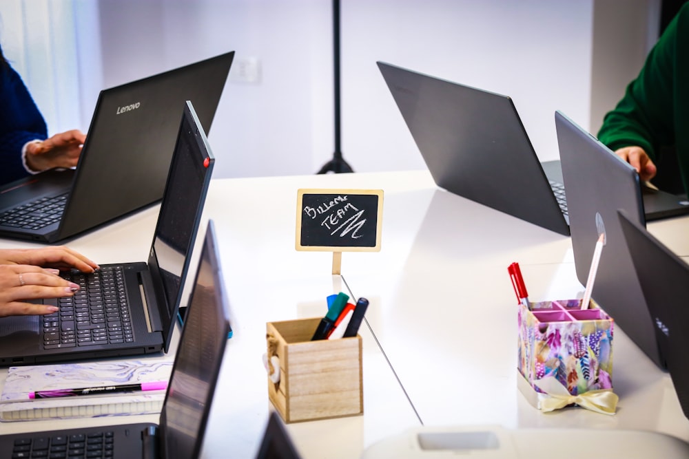 black laptop computer on white table