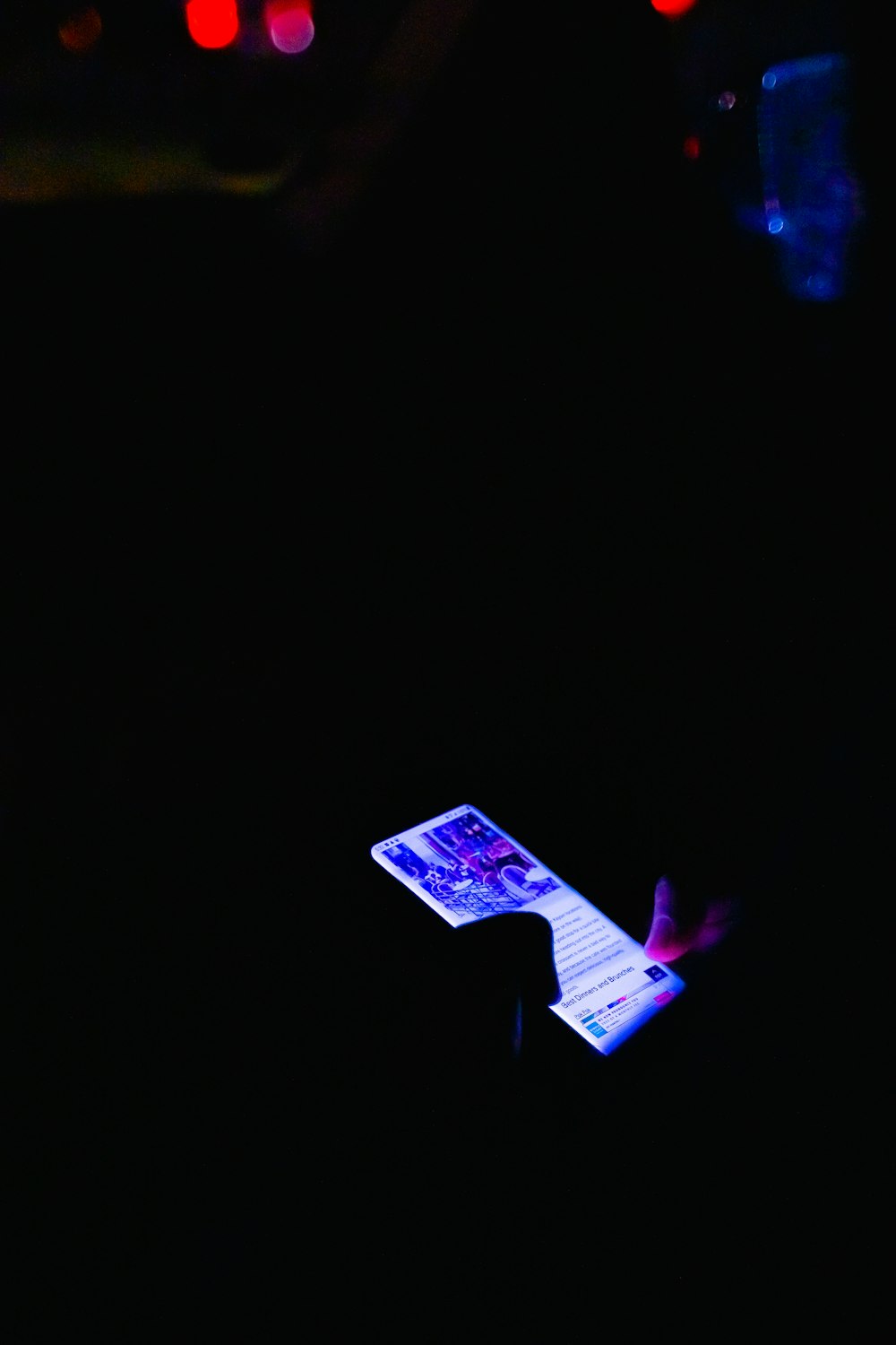 white smartphone on black table