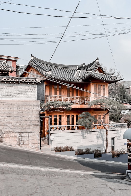 brown and white concrete building during daytime in Bukchon Hanok Village South Korea