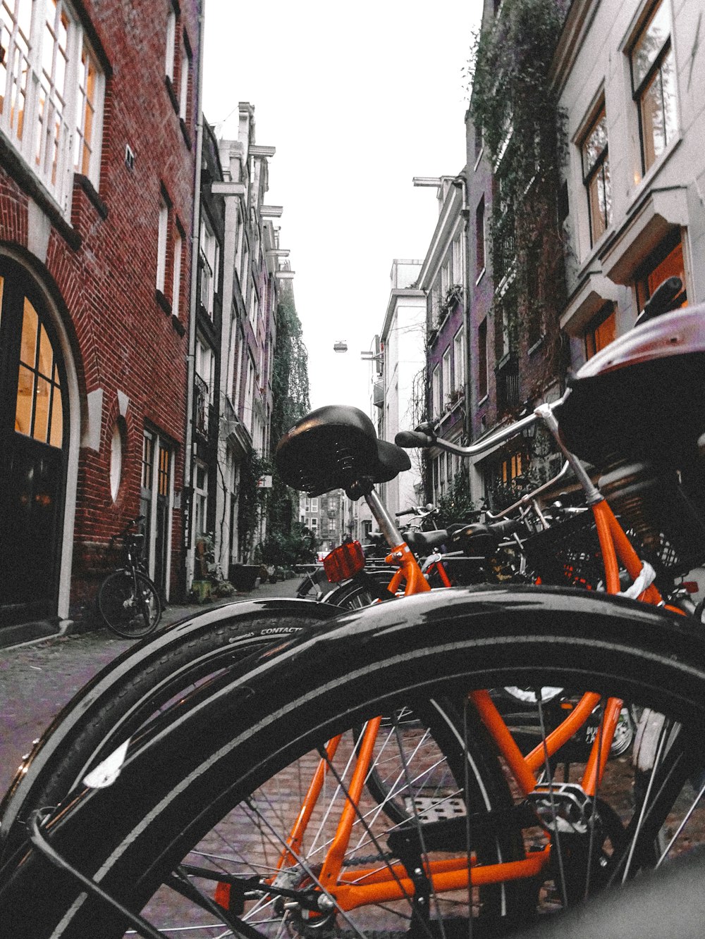 bicycle parked on sidewalk beside building during daytime