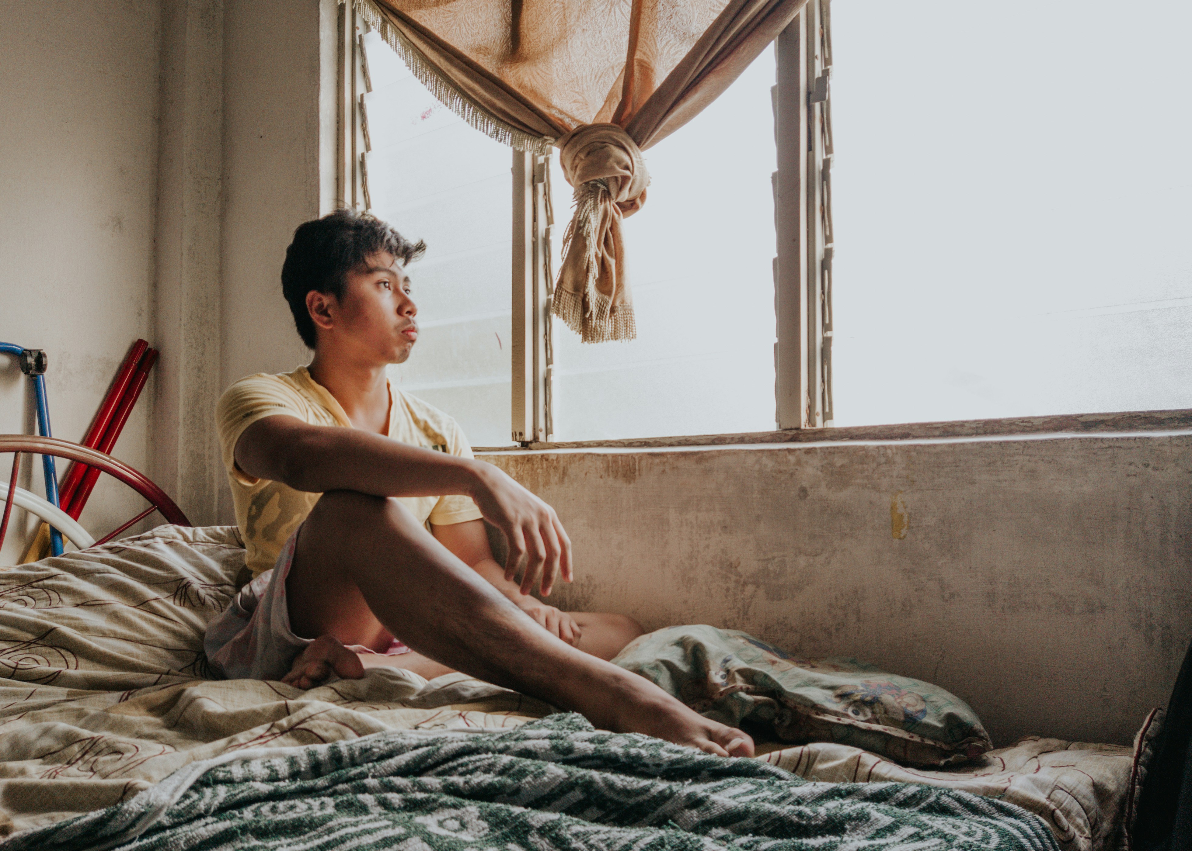 topless woman sitting on bed