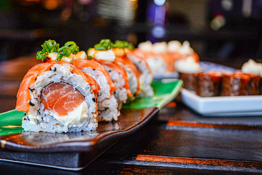 Japanese sushi rolls and sashimi arranged on a plate