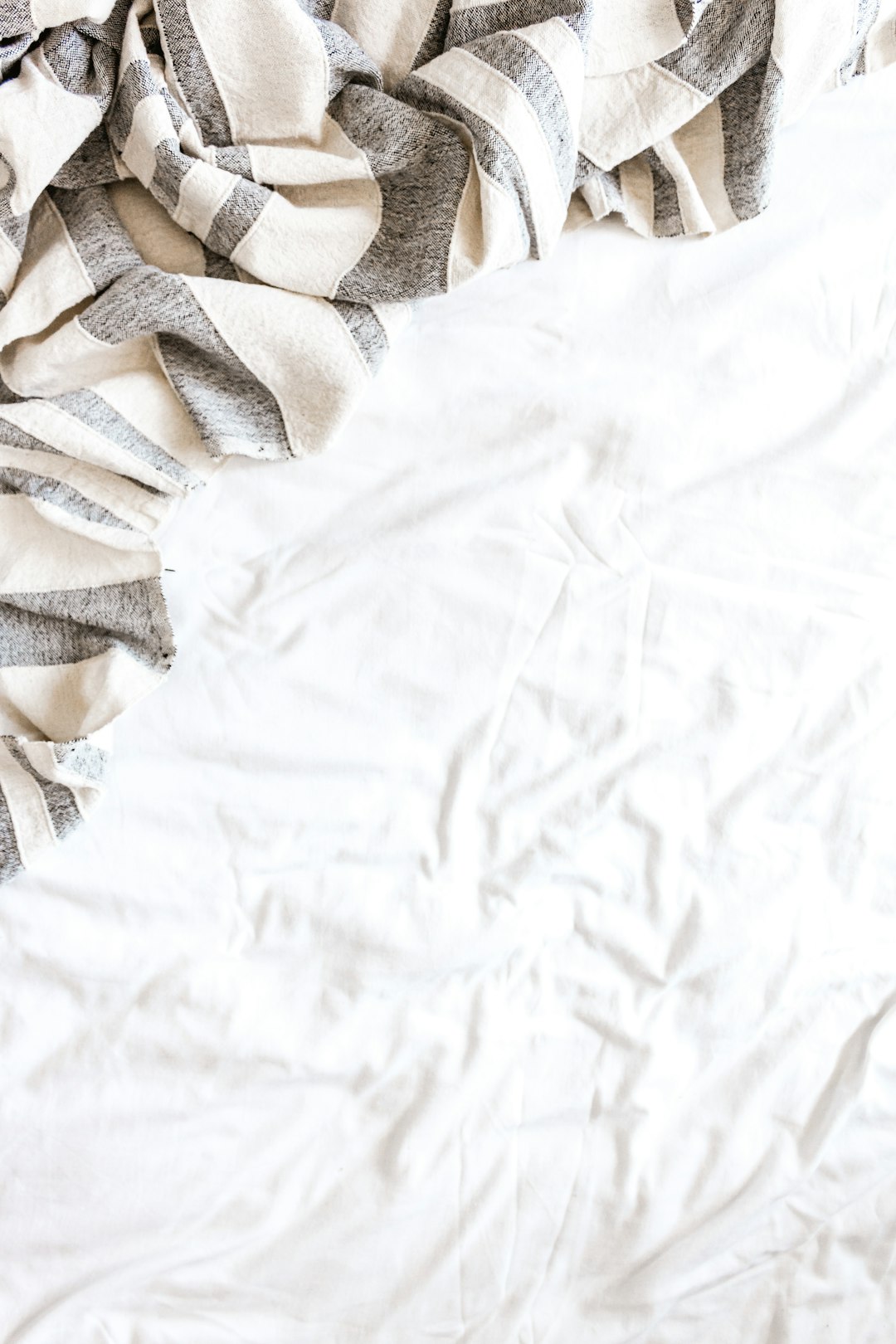  white and brown textile on white textile blanket