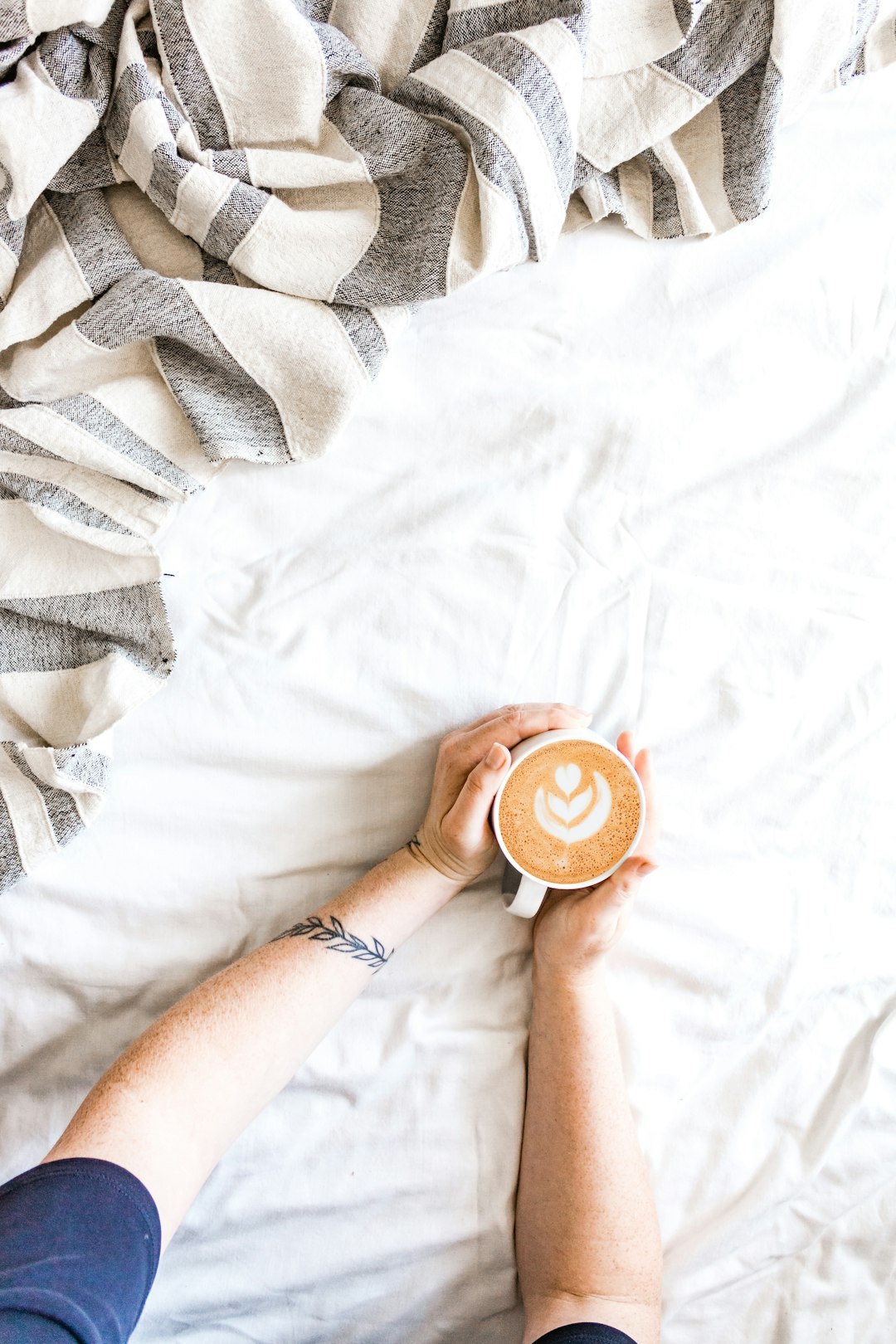 person holding donut on white textile