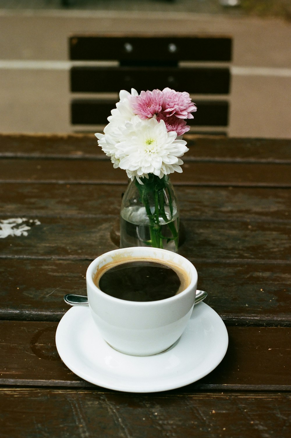 white ceramic cup with saucer on brown wooden table