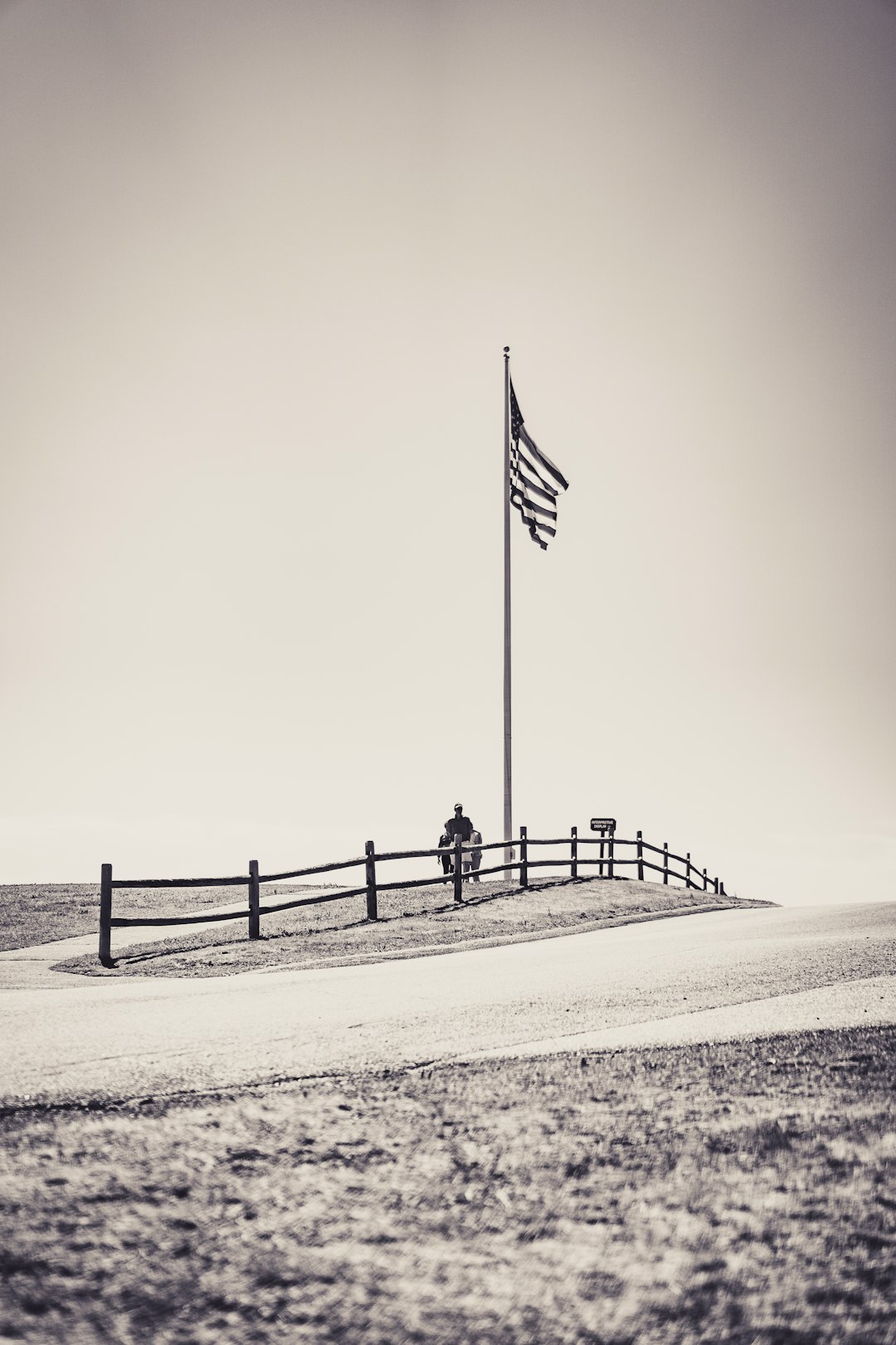 us a flag on pole on white sand during daytime