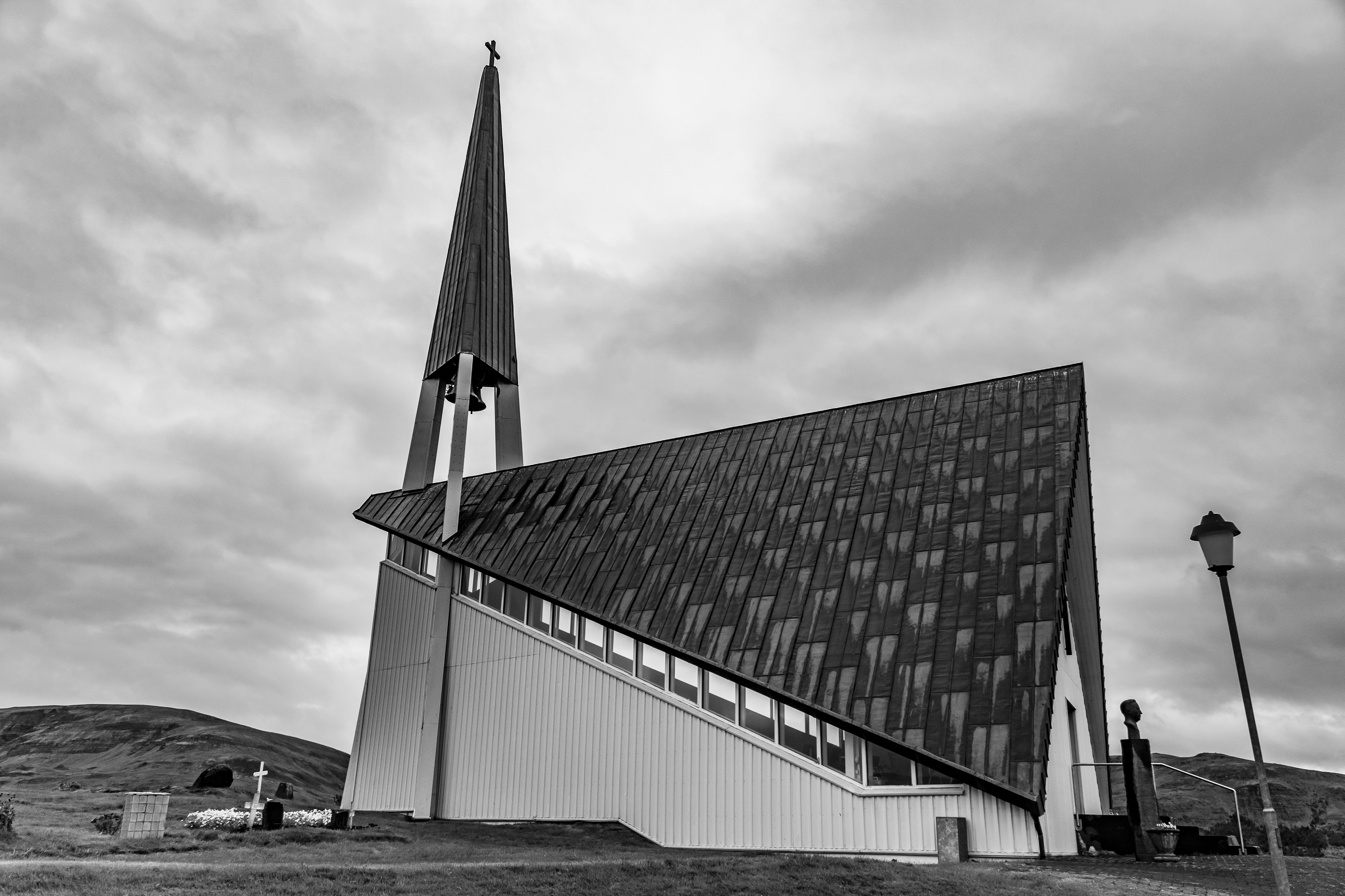 grayscale photo of building under cloudy sky