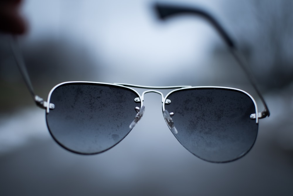 black framed sunglasses on white surface