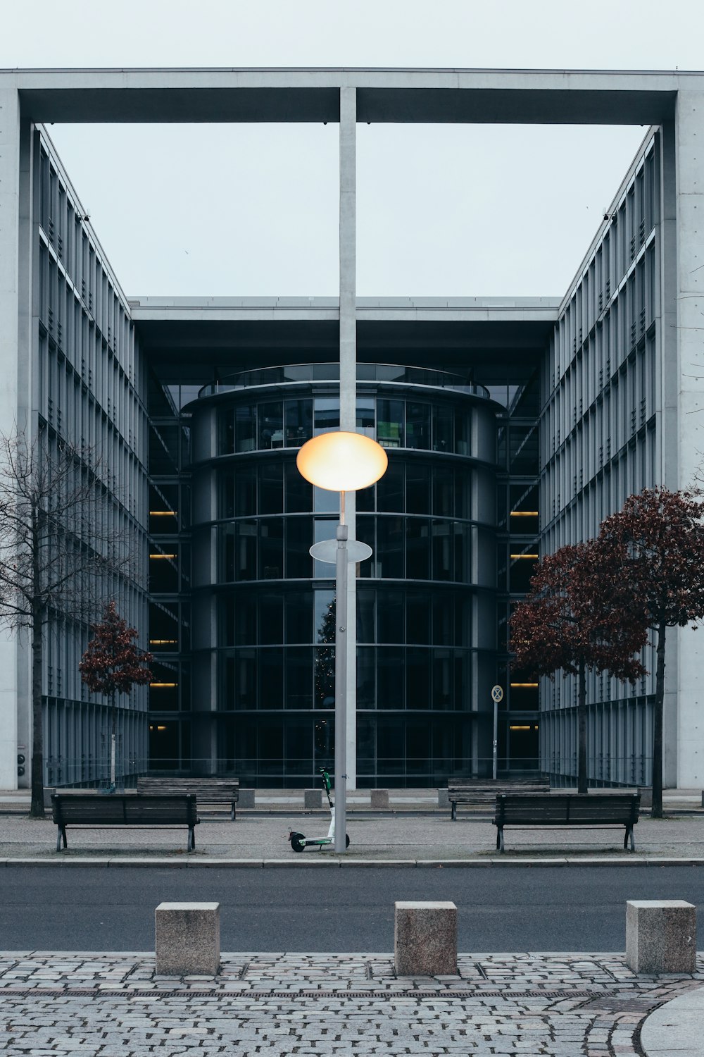 white street light near gray concrete building during daytime