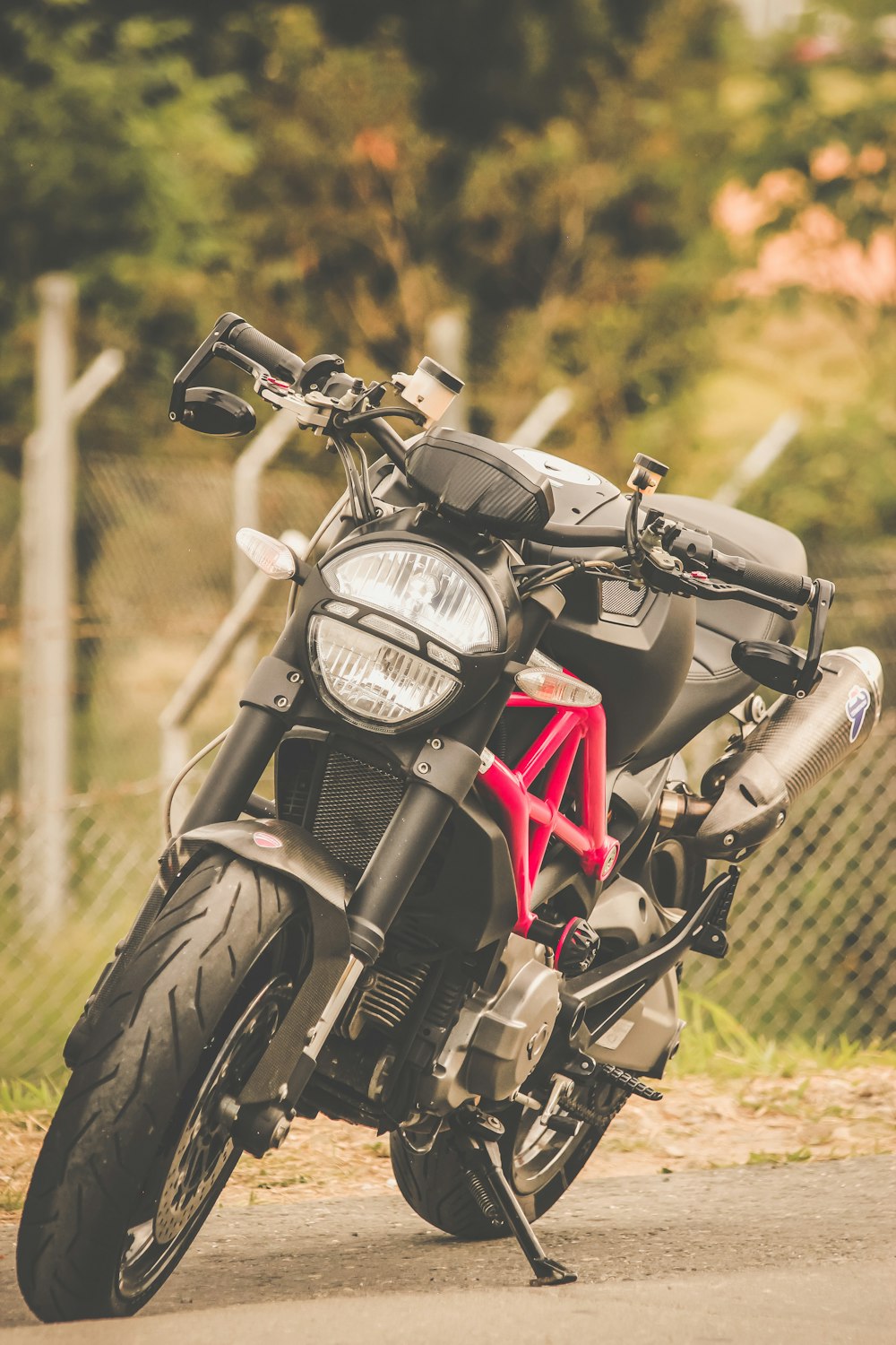 black and red motorcycle on green grass field during daytime