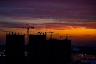 Sunset skyline featuring the economic zone’s growth with cranes and construction in progress.