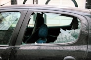 person in blue denim jeans sitting inside car