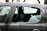 person in blue denim jeans sitting inside car