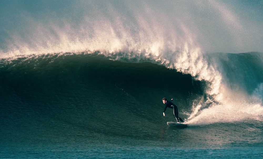 man surfing on ocean waves during daytime