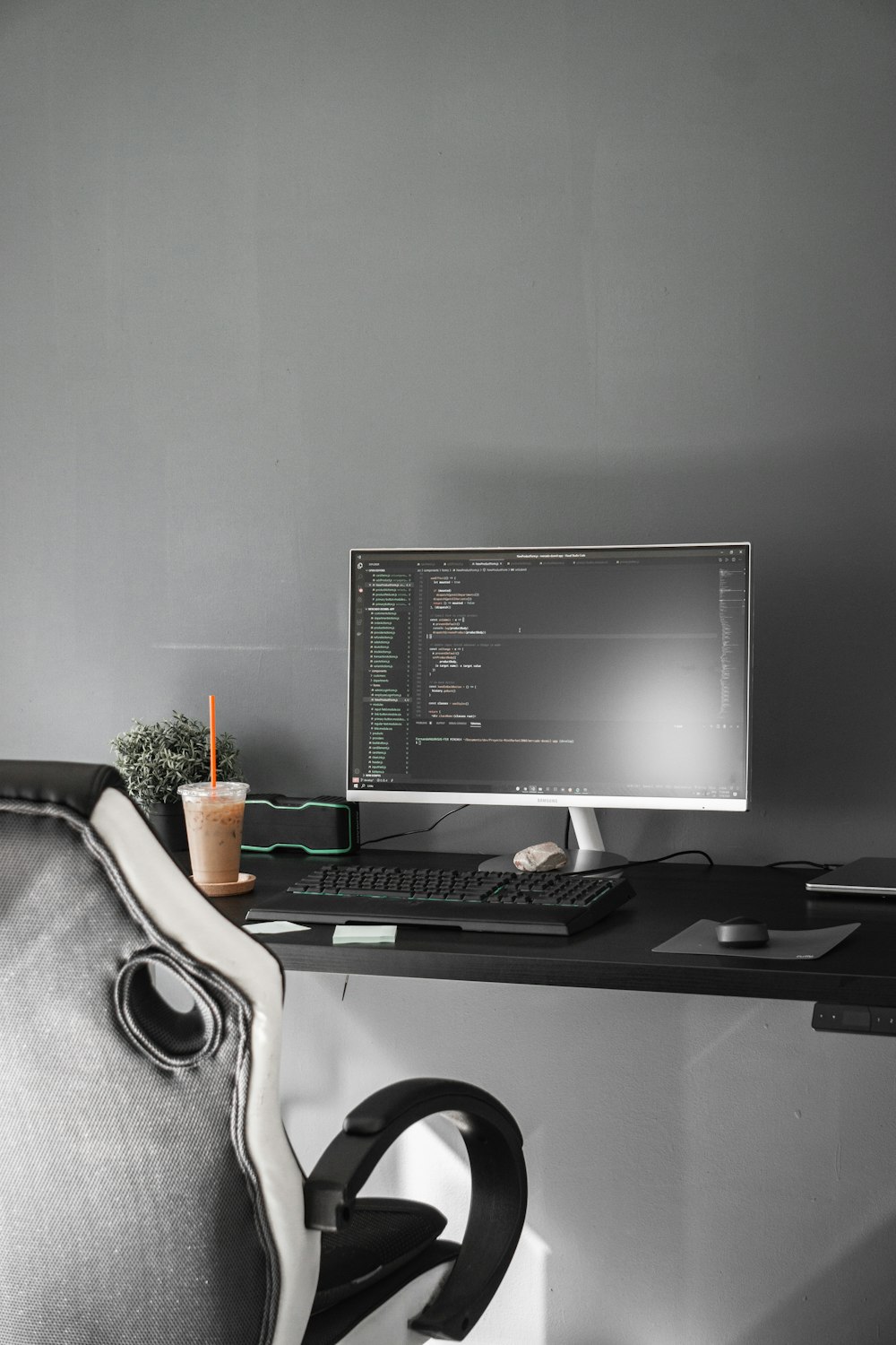 black flat screen computer monitor on black wooden desk