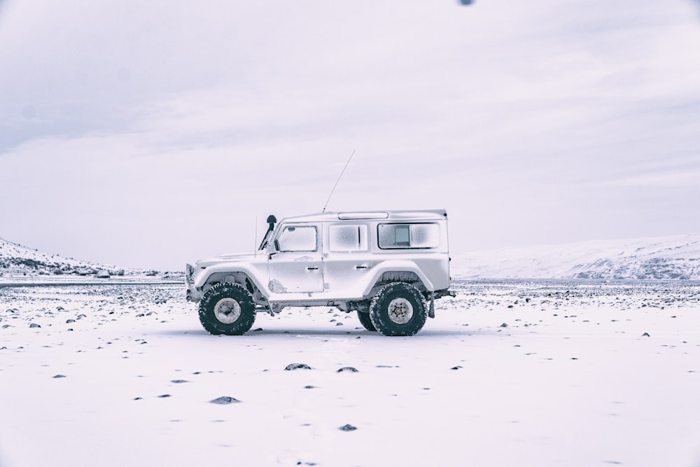 white suv on white sand during daytime