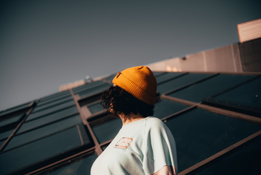 person in white shirt and yellow knit cap