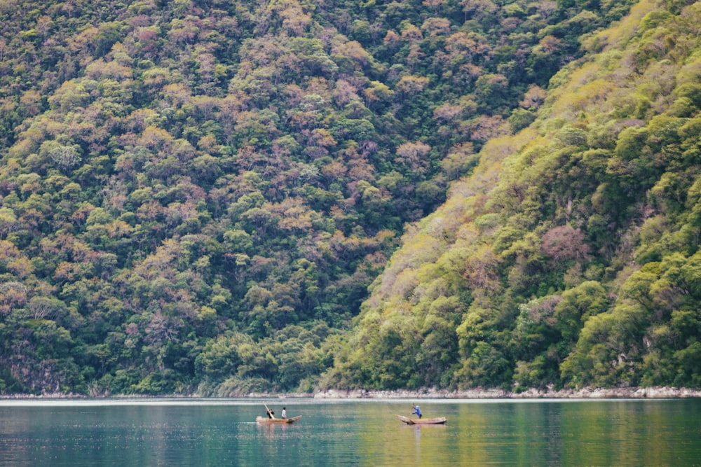 people riding on boat on river during daytime