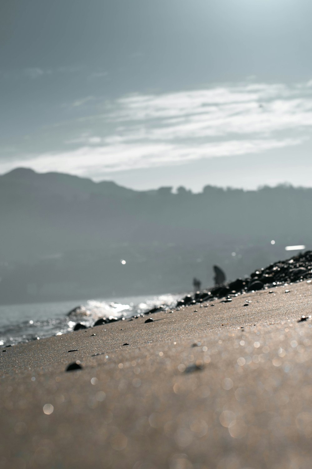 brown sand near body of water during daytime