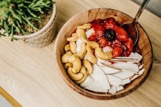 sliced strawberries on brown wooden bowl