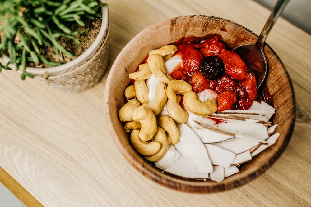 sliced strawberries on brown wooden bowl