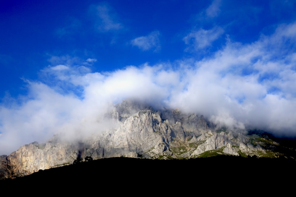 white clouds over gray mountain