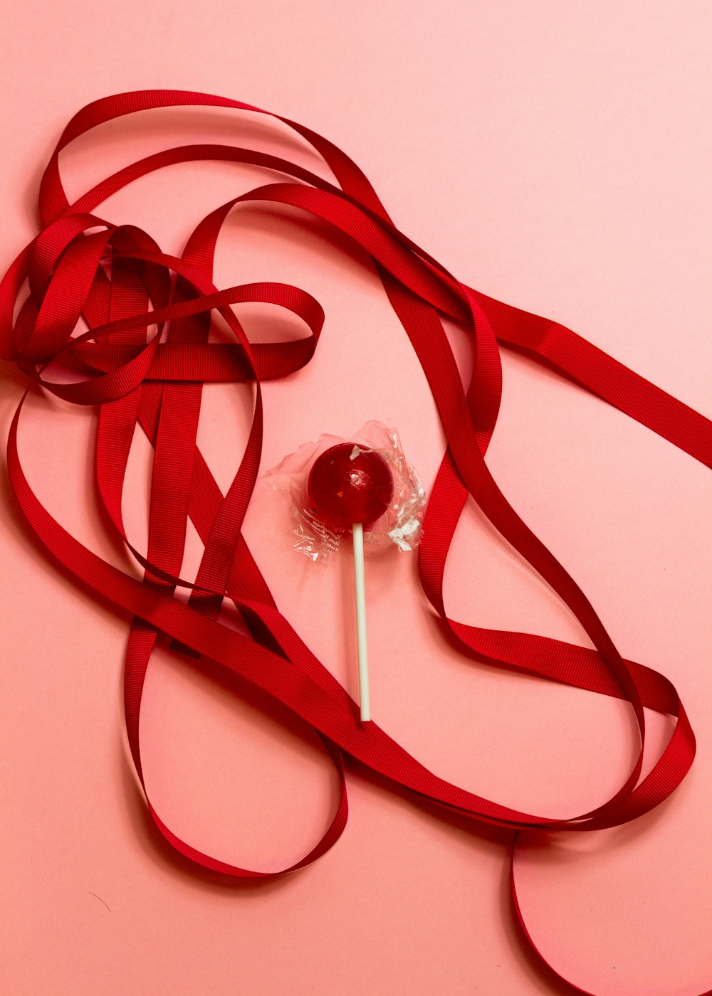 red ribbon on white surface