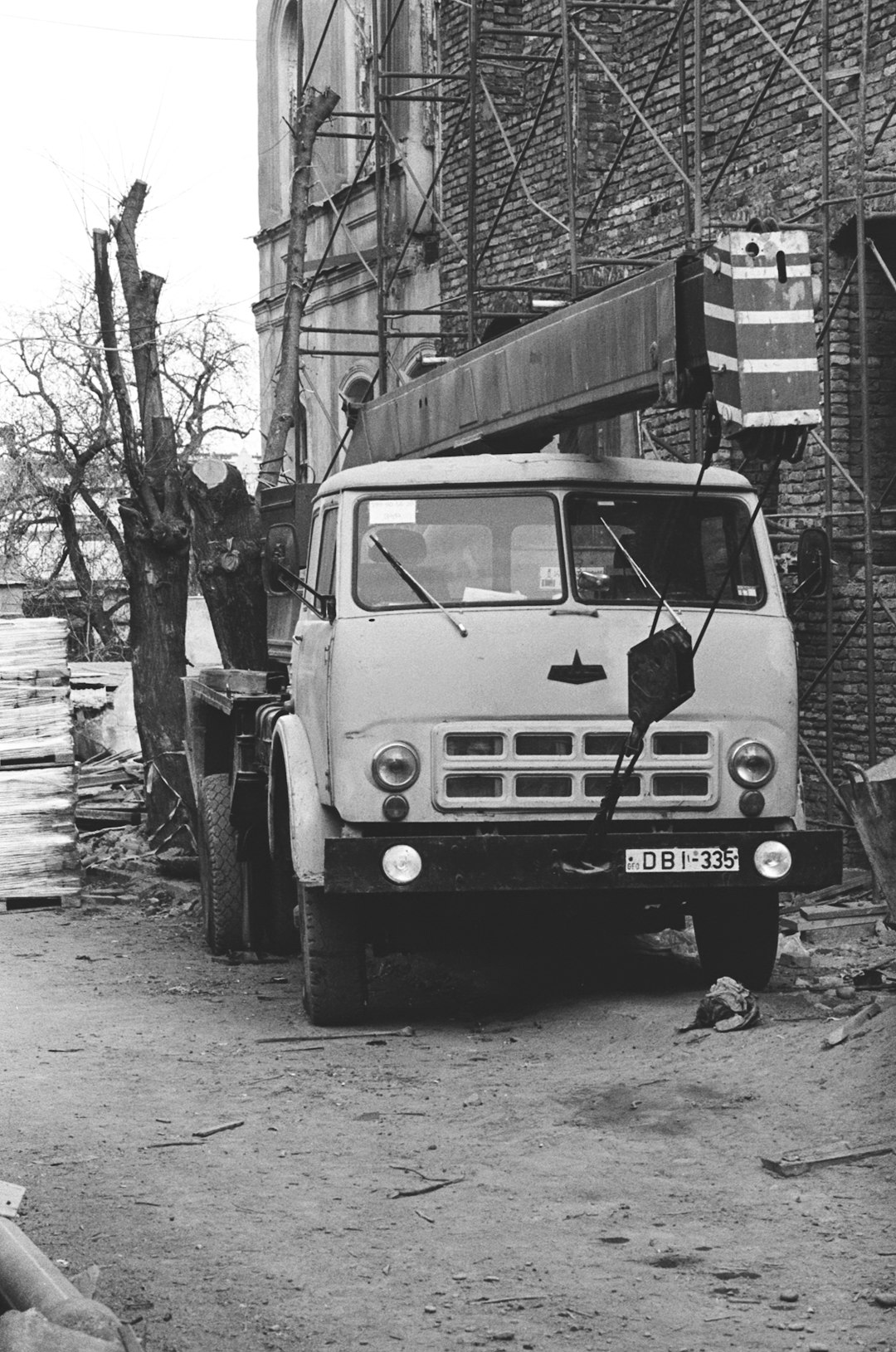 grayscale photo of volkswagen t-2 van parked beside tree